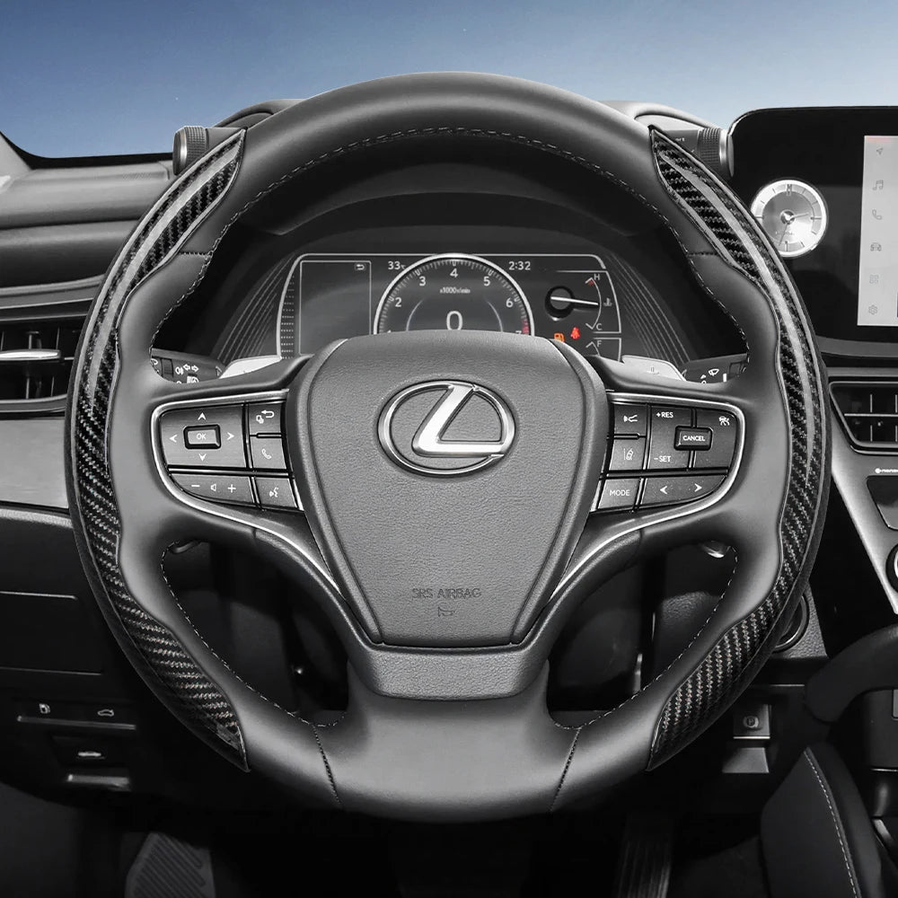 A close-up view of a black steering wheel with carbon fiber texture covers and quick-release segments.