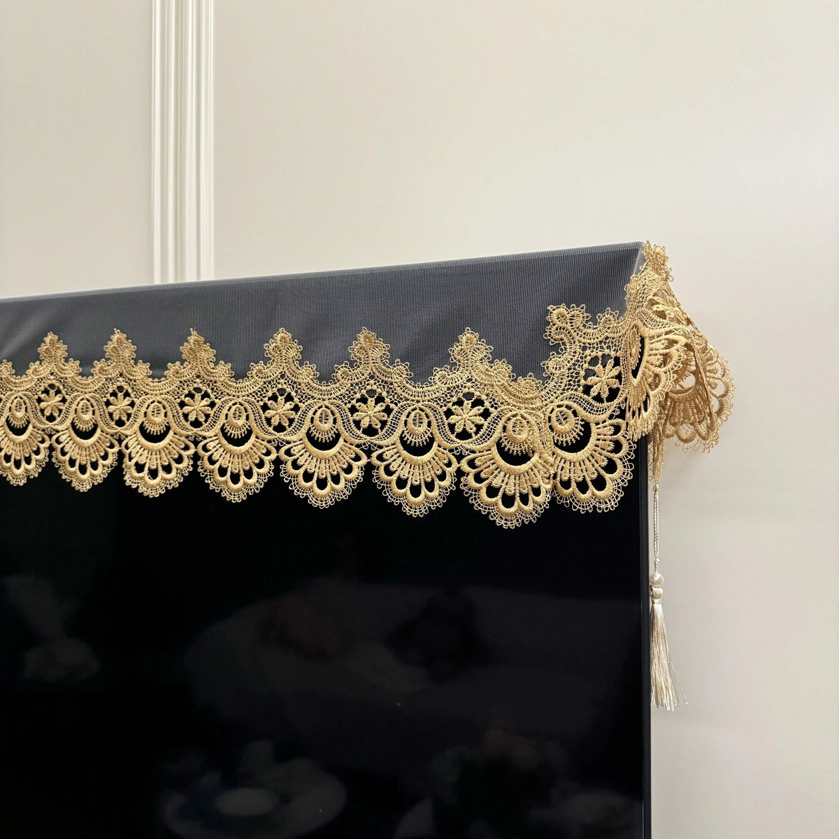 Black table runner featuring gold embroidered mesh lace trim and pendants