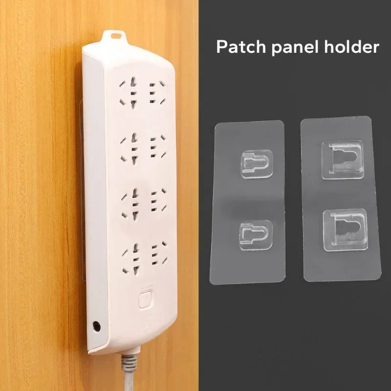 A white patch panel holder and three transparent adhesive wall hooks are shown against a wooden background.