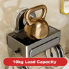 A brass-colored gym weight is mounted on a chrome wall-mounted soap dish with a drain tray.