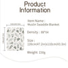 A flat lay of a white muslin swaddle blanket featuring a green botanical print, shown with dimensions and weight information.