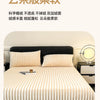 A close-up of a thick, ribbed, cream-colored knit fitted bed sheet displayed on a bed.