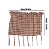 A beige plaid oven skirt with a ruffled trim displayed flat.