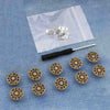 A small silver snap button kit is displayed on a translucent plastic bag against a blue denim background.
