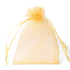 A clear yellow organza drawstring gift bag with thin gold string, used for storing small items.