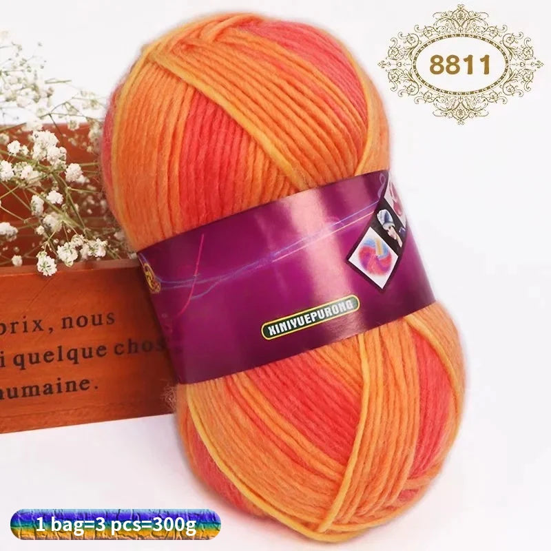 A ball of gradient orange and red wool blend yarn for knitting