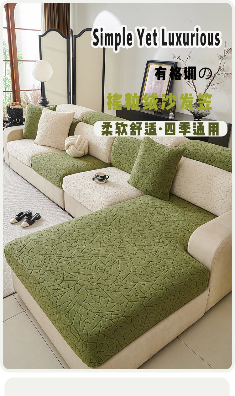 A light beige sofa covered with a green jacquard fleece fabric and matching pillows in a bright room.