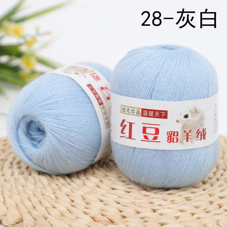 A ball of light blue yarn labeled 28-silver, ready for knitting or crochet.