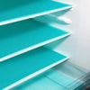 A close-up view of three stacked teal silicone shelf liners for refrigerators.