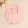 A set of three pink soft cotton ruffle bibs for babies displayed on a light background.