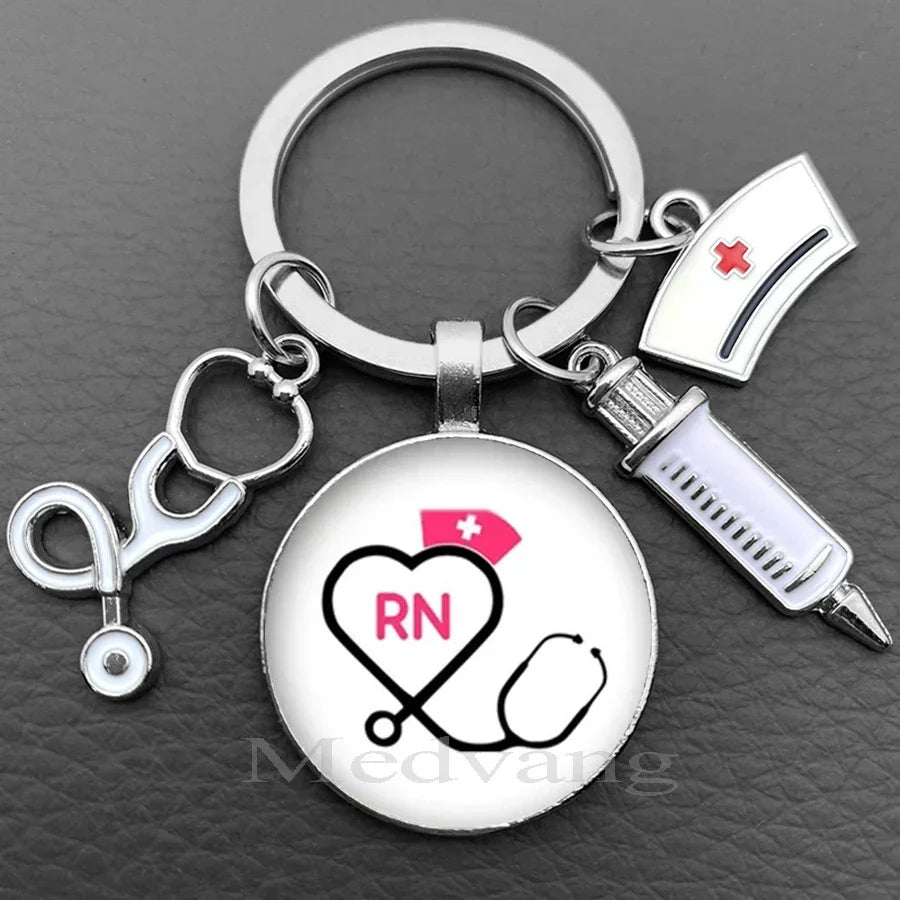 Silver nurse keychain featuring a heart and stethoscope design with an attached glass dome.