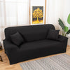 A black silky soft stretchable sofa cover displayed on a wooden floor.