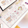 A pink and white kawaii cartoon illustration desk mat featuring cute bear and cat characters with a non-slip rubber base.