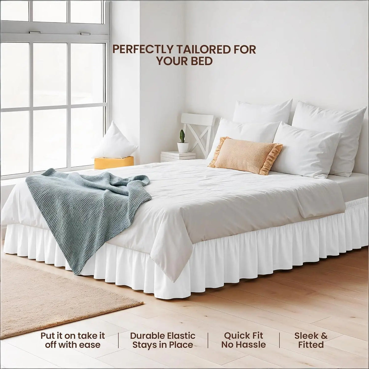 White bed with a ruffled skirt and white linens in a bright room.