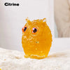Handcrafted crystal owl figurine made of yellow resin with a natural crushed stone finish