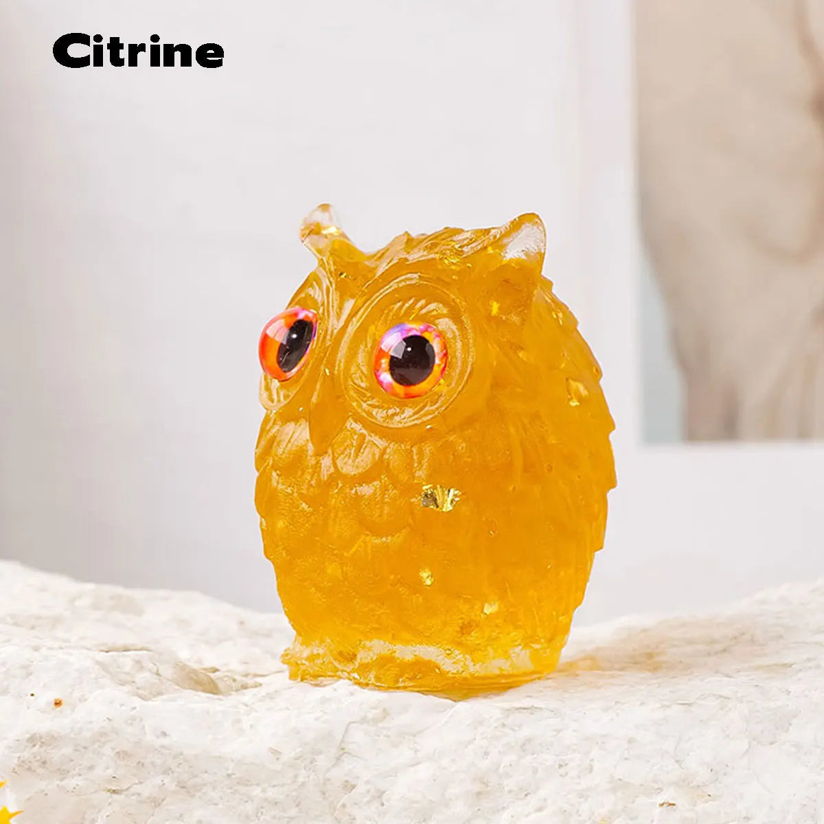 Handcrafted crystal owl figurine made of yellow resin with a natural crushed stone finish