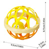 A yellow and orange baby sensory spinning rattle toy set with a circular frame.