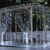 LED curtain lights create a sparkling canopy over an outdoor area for decoration.
