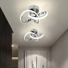 Modern clover-shaped LED ceiling light fixture with a silver finish and white glowing rings.