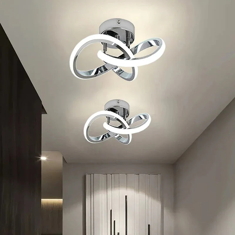 Modern clover-shaped LED ceiling light fixture with a silver finish and white glowing rings.