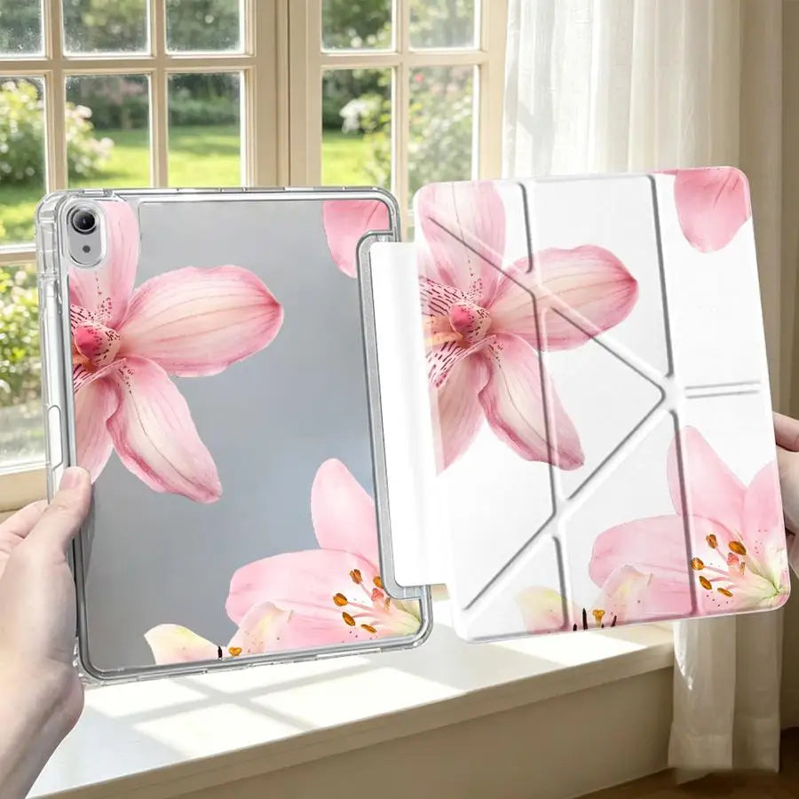 A pink lily flower tablet case with a pen holder is displayed on a windowsill next to a window.