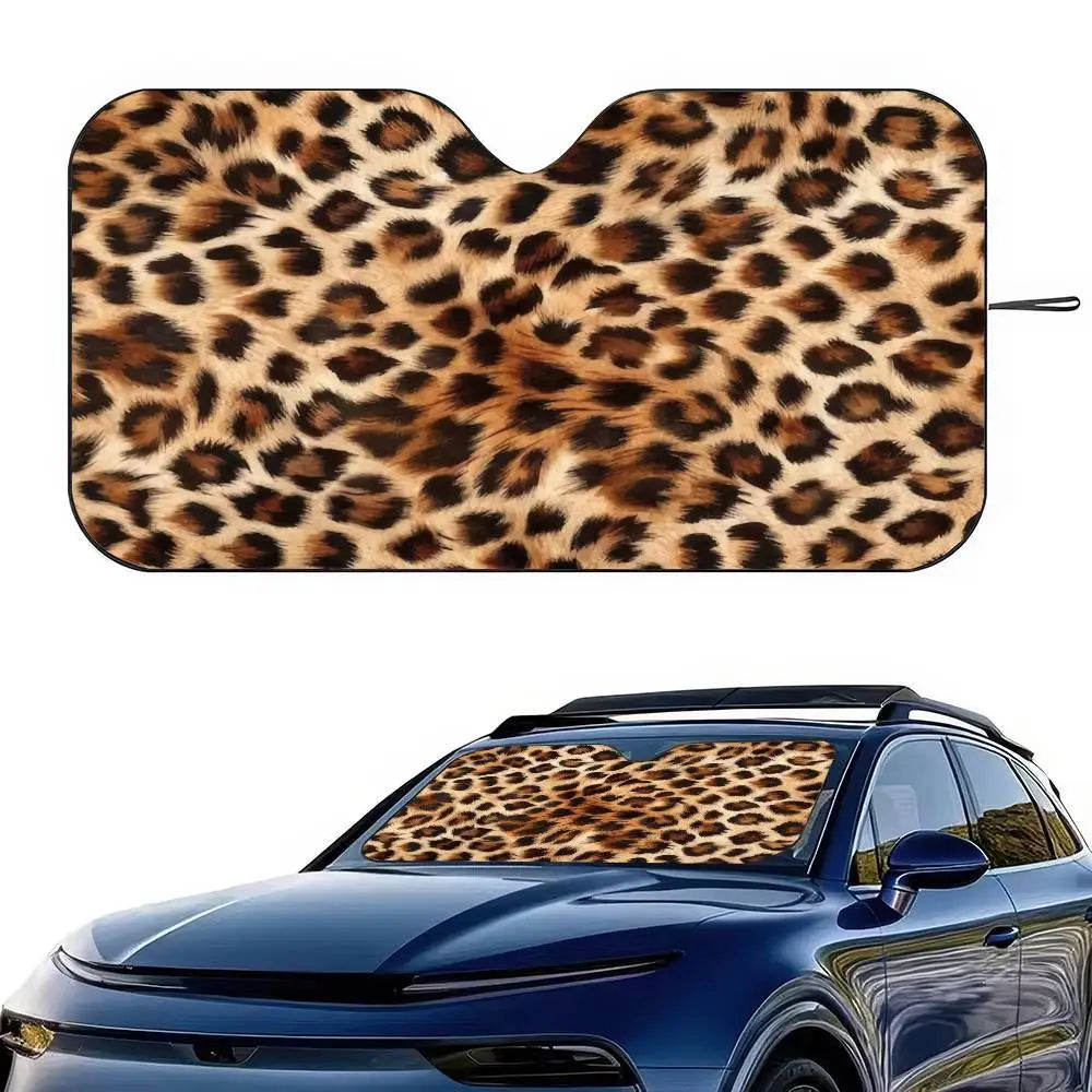 Leopard print car windshield sunshade placed on a blue car windshield.