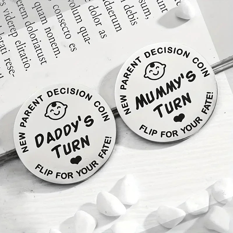Two double-sided decision coins labeled New Parent Decision Coin Daddy's Turn and Mummy's Turn Flip for Your Fate