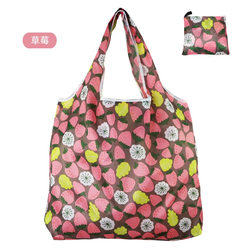 A pink and green patterned reusable shopping tote bag with a handle.