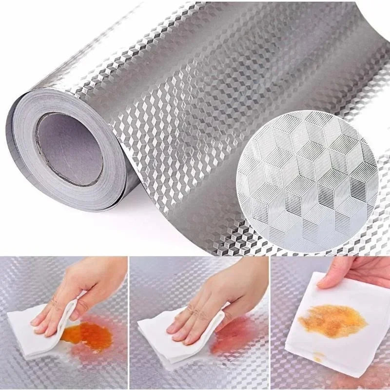 Roll of aluminum foil peel-and-stick kitchen backsplash wall sticker showing texture and application on a surface.