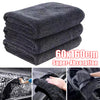 Stack of dark gray microfiber car drying towels demonstrating super-absorption for vehicle cleaning