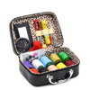 Portable faux leather sewing kit organizer containing various needles, thread, and tools.