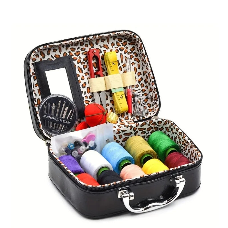 Portable faux leather sewing kit organizer containing various needles, thread, and tools.