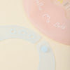 A pink silicone baby bib with the text My Baby and a white silicone teething ring.