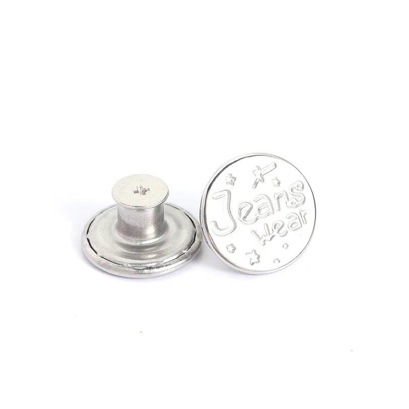 A silver metal button with the word Jeans Wear engraved on it.