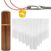 A set of thirty self-threading sewing needles, a gold ring, and a red thread shown next to a wooden cylinder.