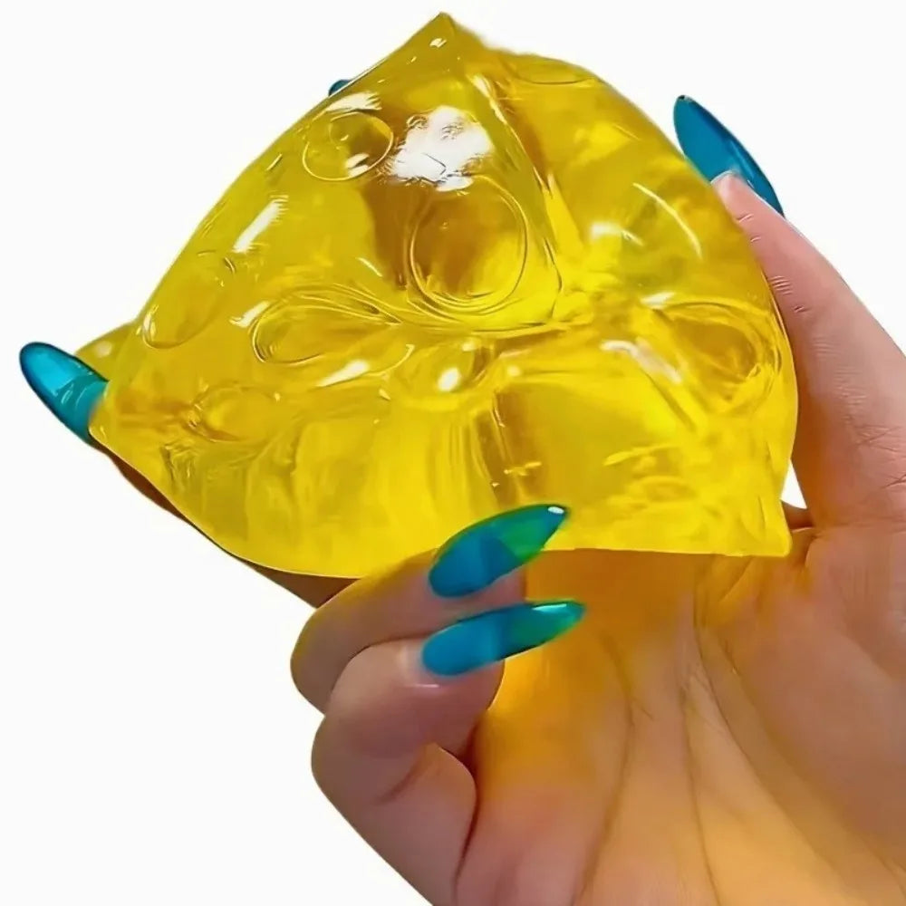 A hand holds a yellow squishy honey cheese fidget toy with blue accents.