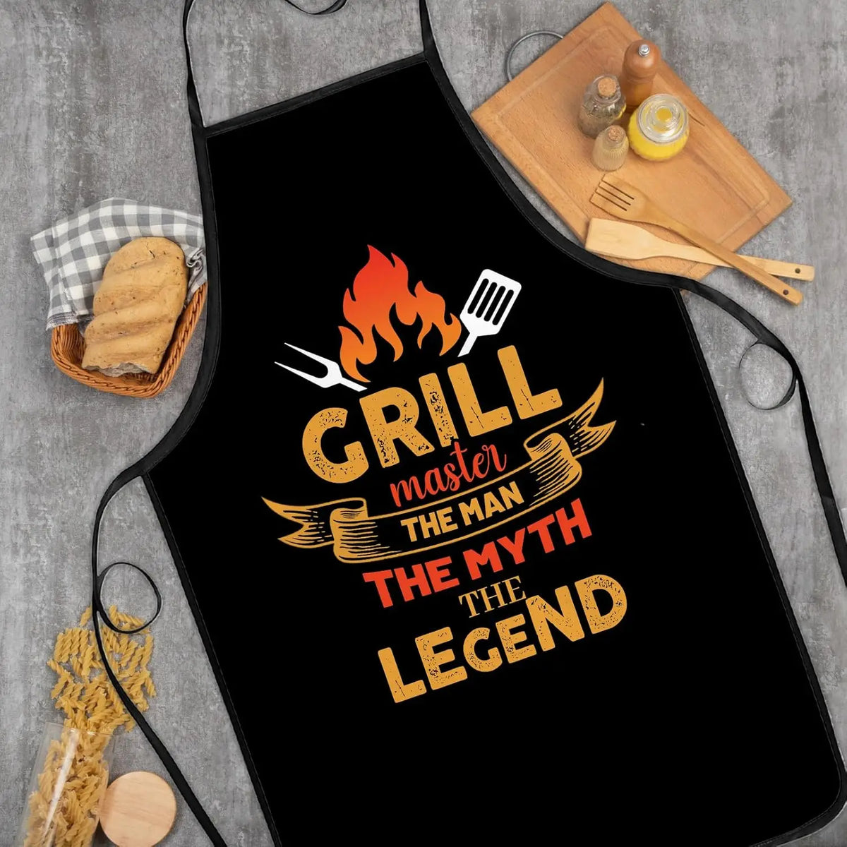 Black apron with orange text featuring a grill master theme and fire icon