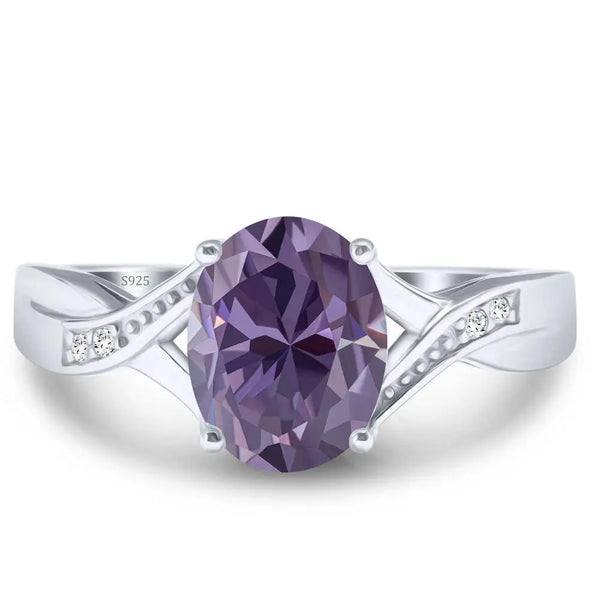 A dainty moissanite fairy charm ring in 925 sterling silver featuring a purple gemstone and small diamonds.