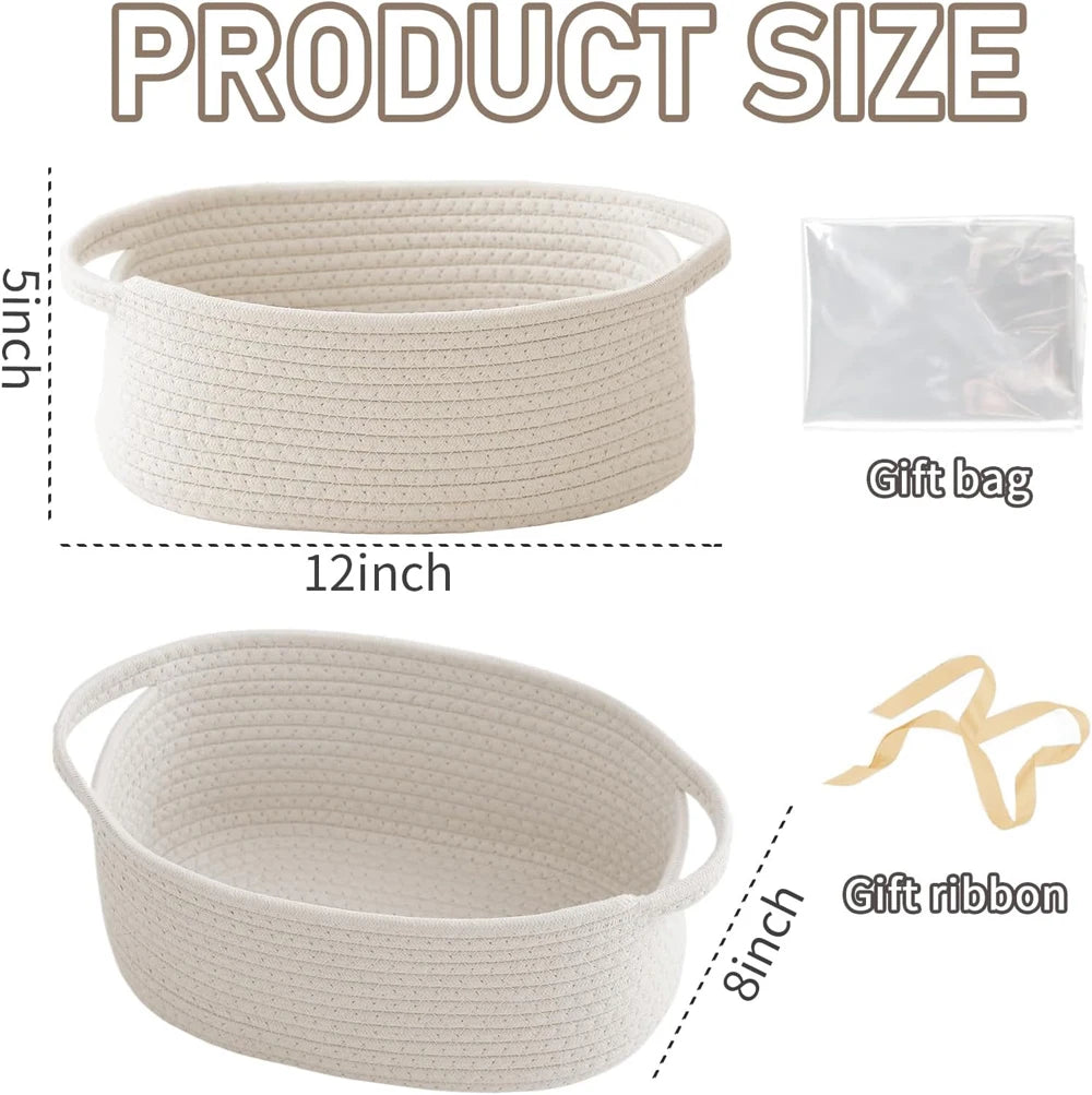 A beige handwoven rope storage basket with handles is shown next to a gift bag and a piece of gift ribbon.