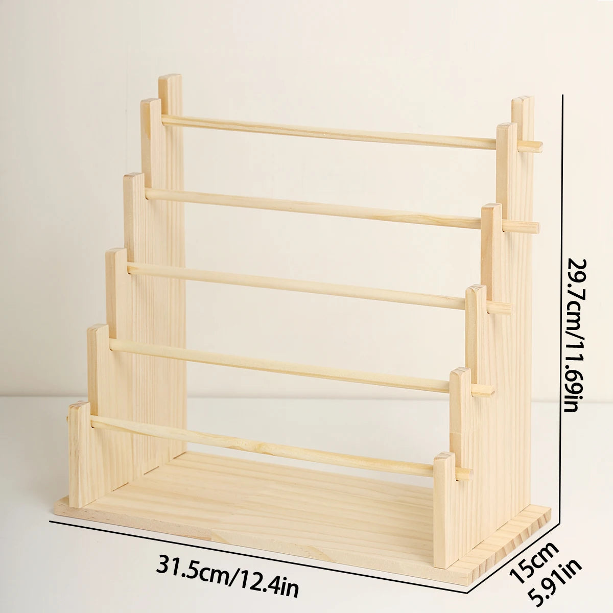 A solid wood ladder jewelry organizer with multiple storage tiers shown in a side view.