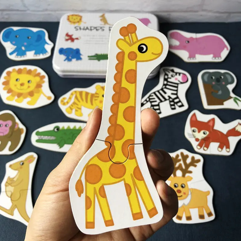 A hand holds a wooden giraffe puzzle piece from an animal and vehicle set, showing various animal shapes.