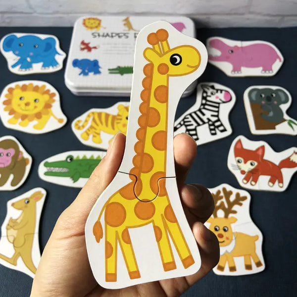 A hand holds a wooden giraffe puzzle piece from an animal and vehicle set, showing various animal shapes.