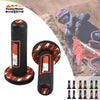 A set of black motorcycle handlebar grips with vibration dampening features shown next to a person riding a motorcycle.