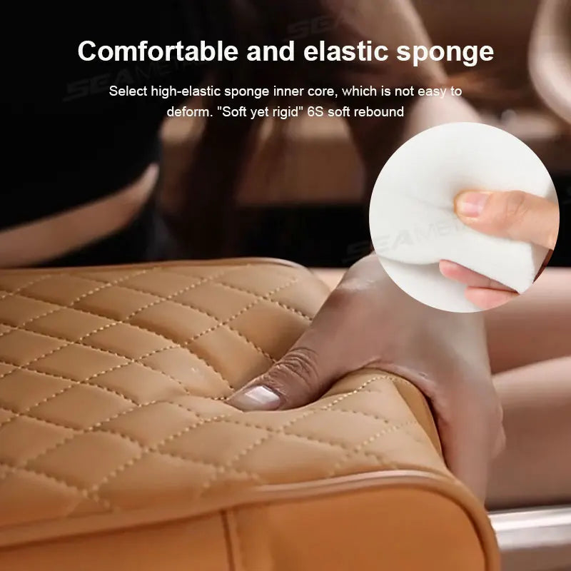 A hand is pressing a white elastic sponge inner core into a tan leather car armrest cushion.