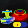 A glowing blue and yellow musical spinning top is shown against a black background with a close-up view of its design.
