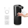 A black touchless automatic soap dispenser is shown dispensing white soap onto a hand.