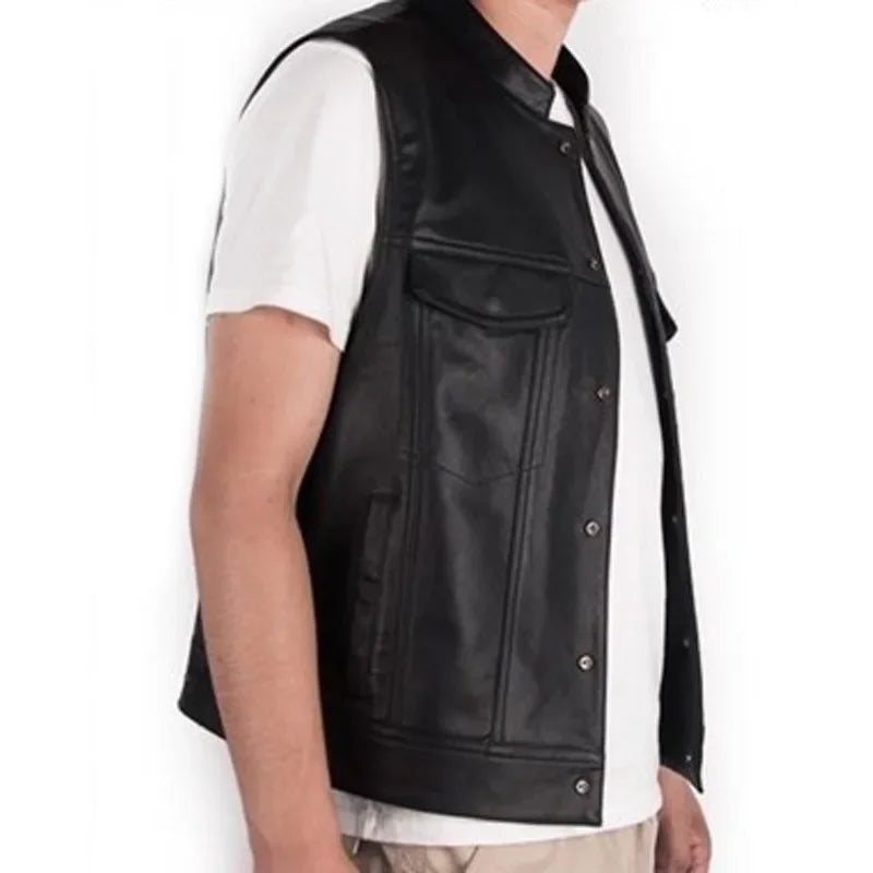 A man wearing a black faux leather biker vest over a white shirt.