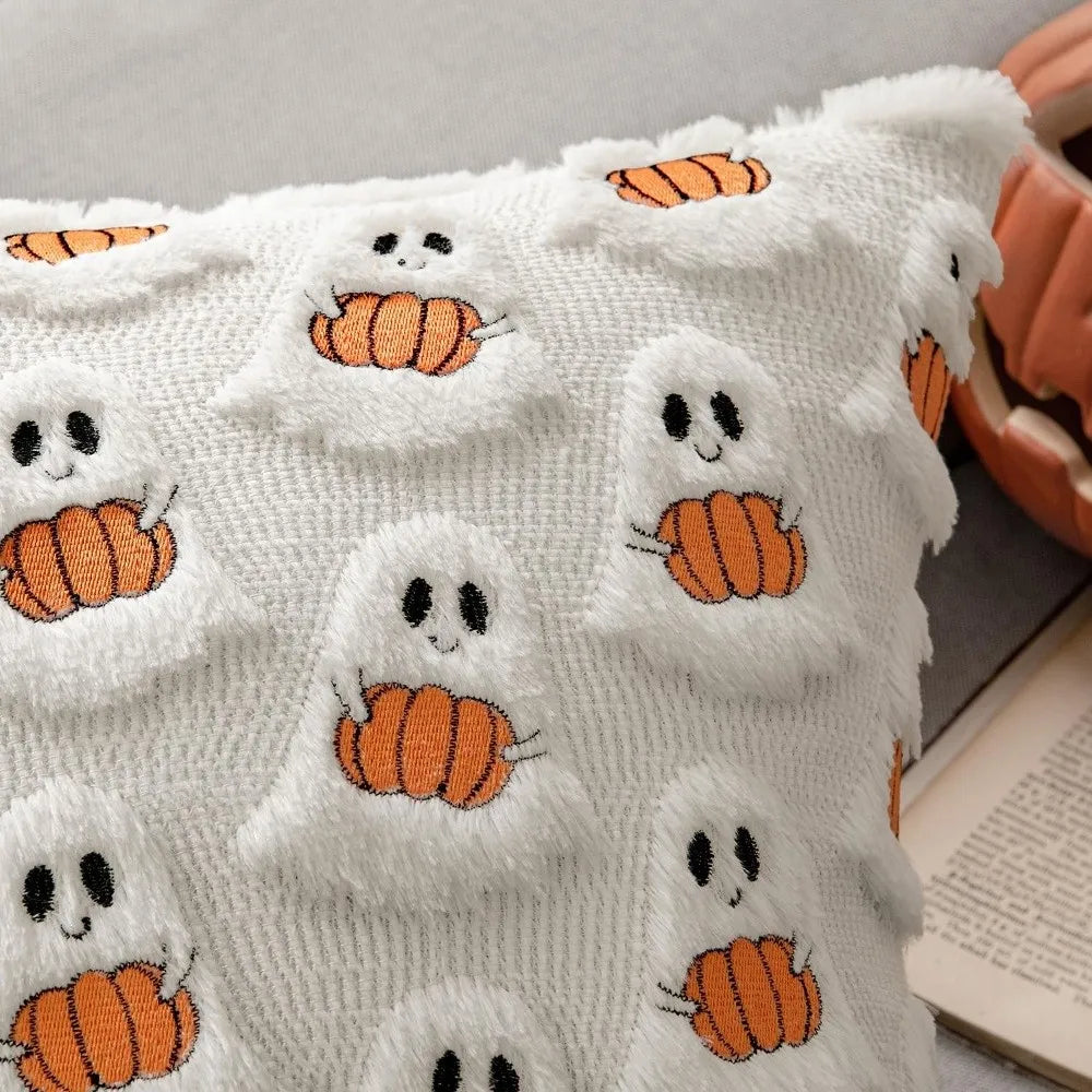 White knitted pillow cover featuring orange pumpkin ghost patterns