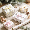 Gift decoration featuring wrapped presents with satin ribbon labels and small teddy bears on a soft background.