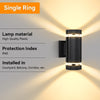 Modern up and down LED wall sconce with a cylindrical glass shade illuminating a wall.